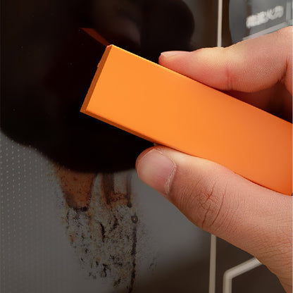 Hand holding an orange rectangular object with a blurred background