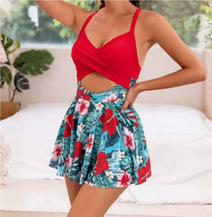 Woman wearing a red top and tropical floral skirt in a bright room.