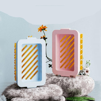 Two high elastic mesh soap foaming boxes on rocks with a light blue background