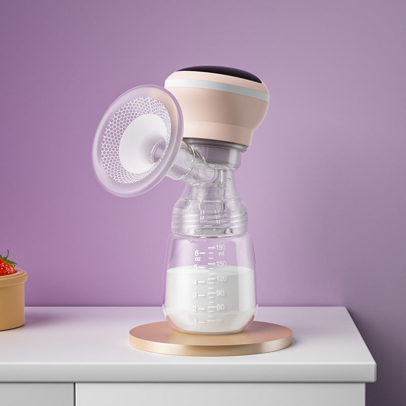 Breast pump with a clear container on a white surface against a purple wall