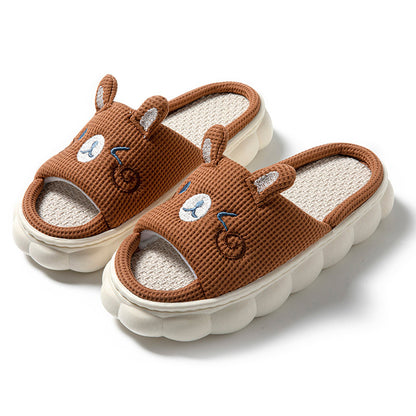 Brown slippers with bear design on a white background