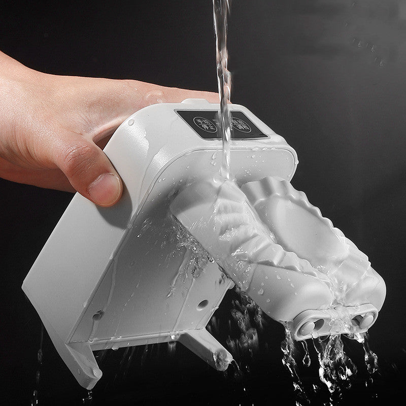 Hand holding a white electronic device with water flowing out against a black background