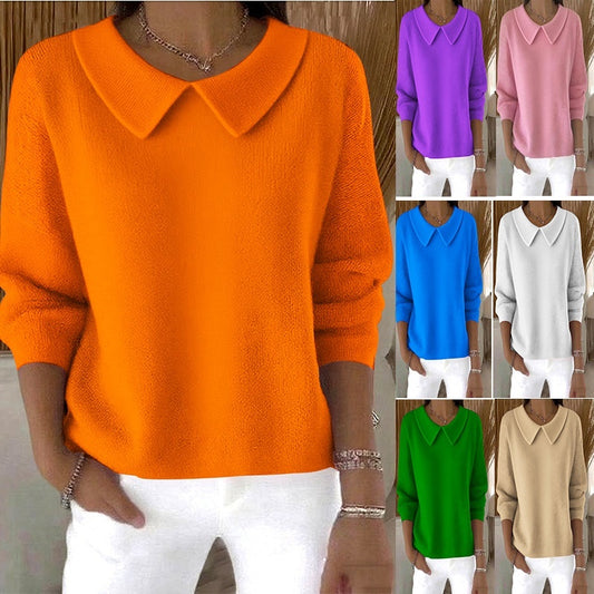 Orange sweater with a collar worn by a person, surrounded by other colored sweaters.