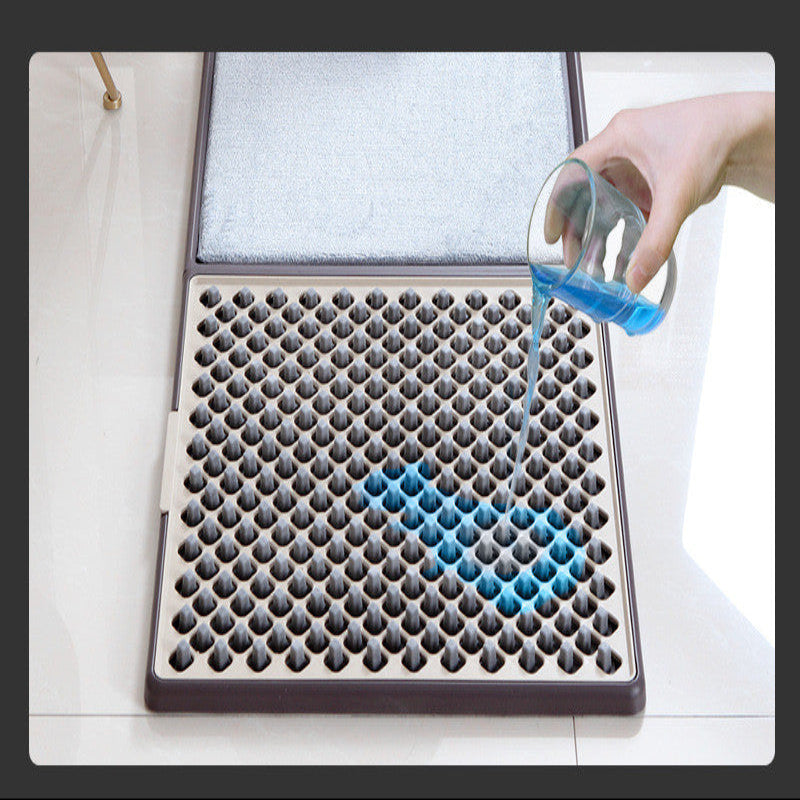 Person using a blue cleaning tool on a textured mat with a white background