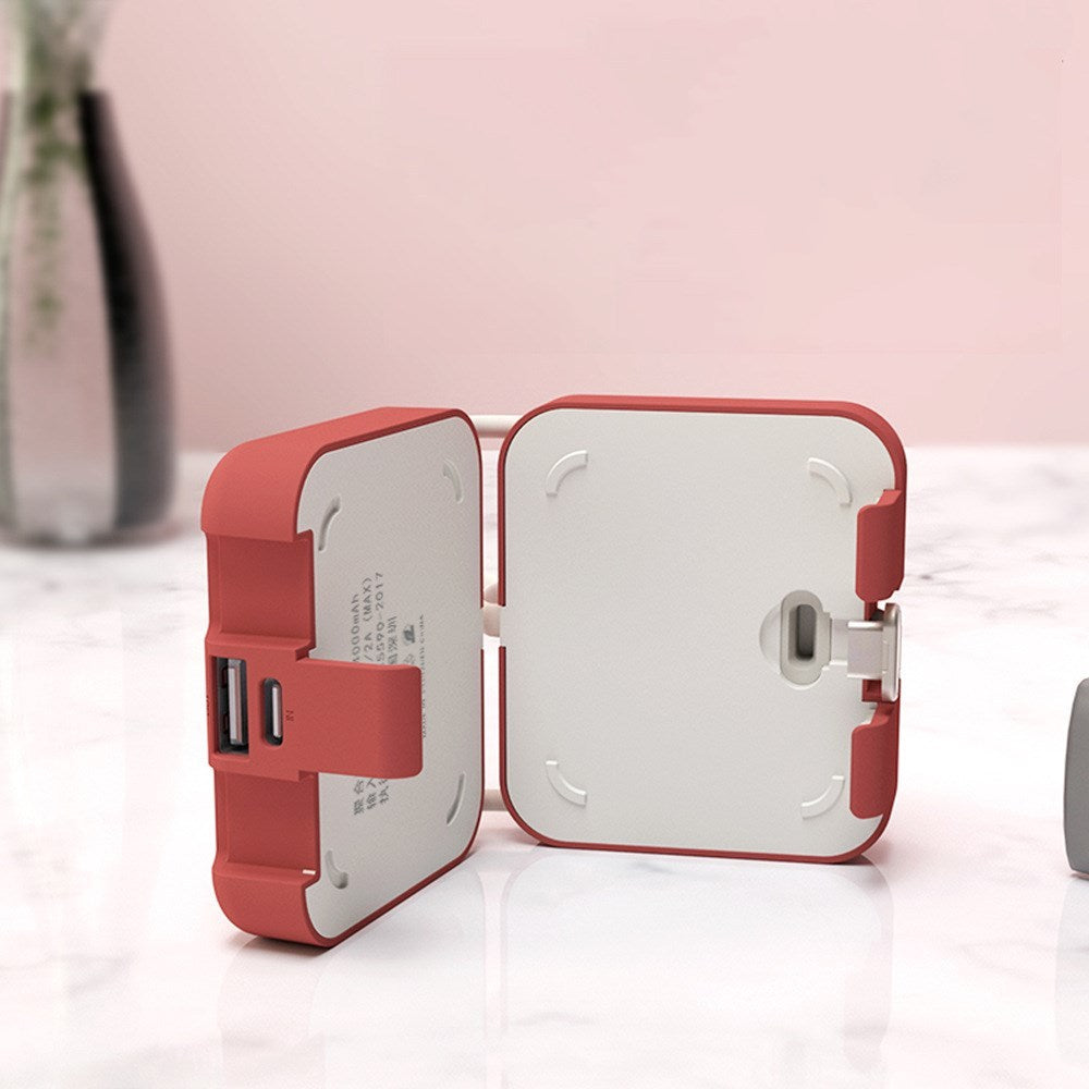Red and white travel adapter on a light pink background