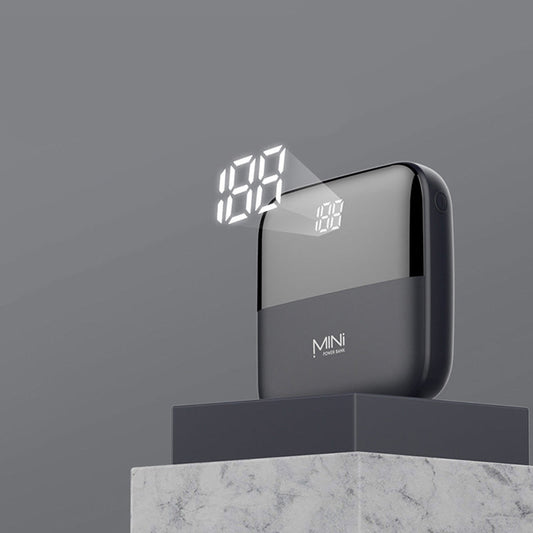 Black power bank with LED display on a gray background