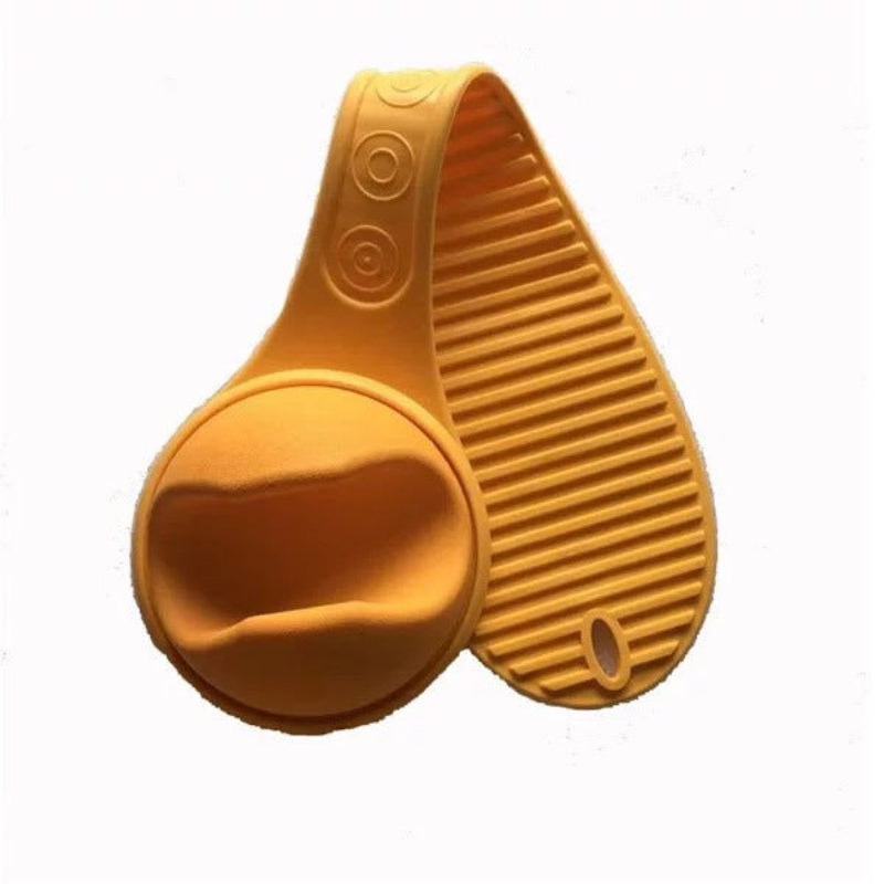 Yellow silicone brush and scrubber on a white background
