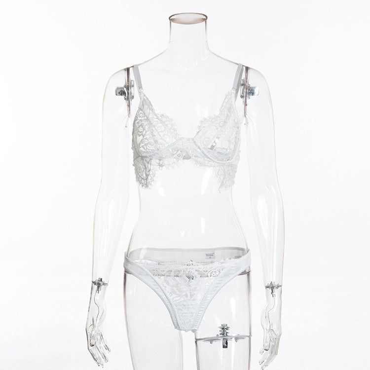 White lace lingerie set on a transparent mannequin against a white background