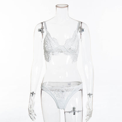 White lace lingerie set on a transparent mannequin against a white background