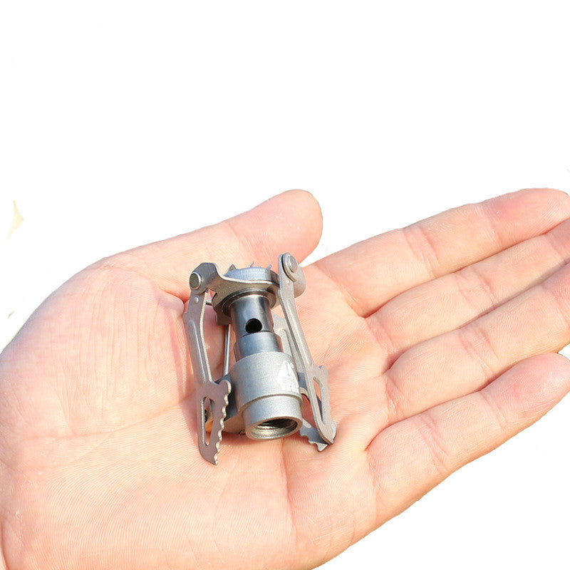 Small metallic object held in a hand on a white background