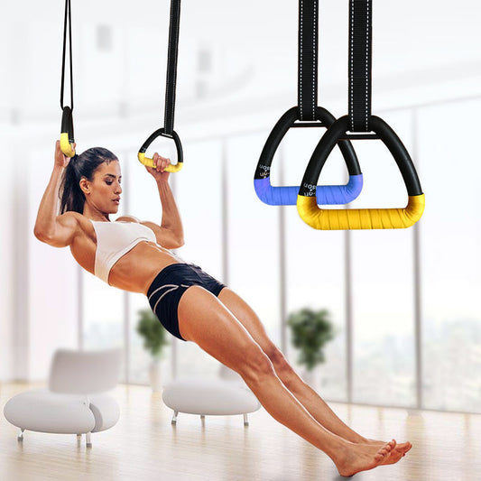 Woman exercising using suspension rings in a home setting