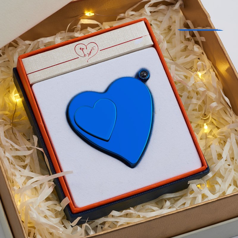 Blue heart-shaped object in a gift box with decorative lights in the background