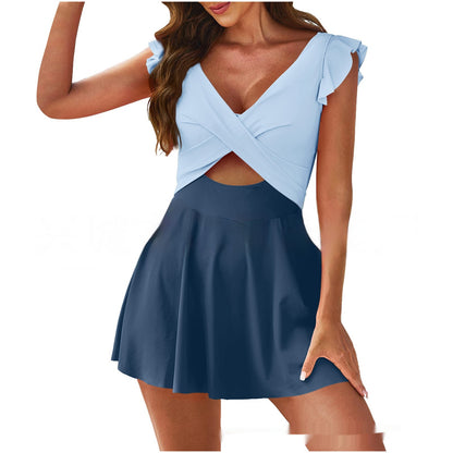 Two-tone dress with light blue top and navy skirt on a white background
