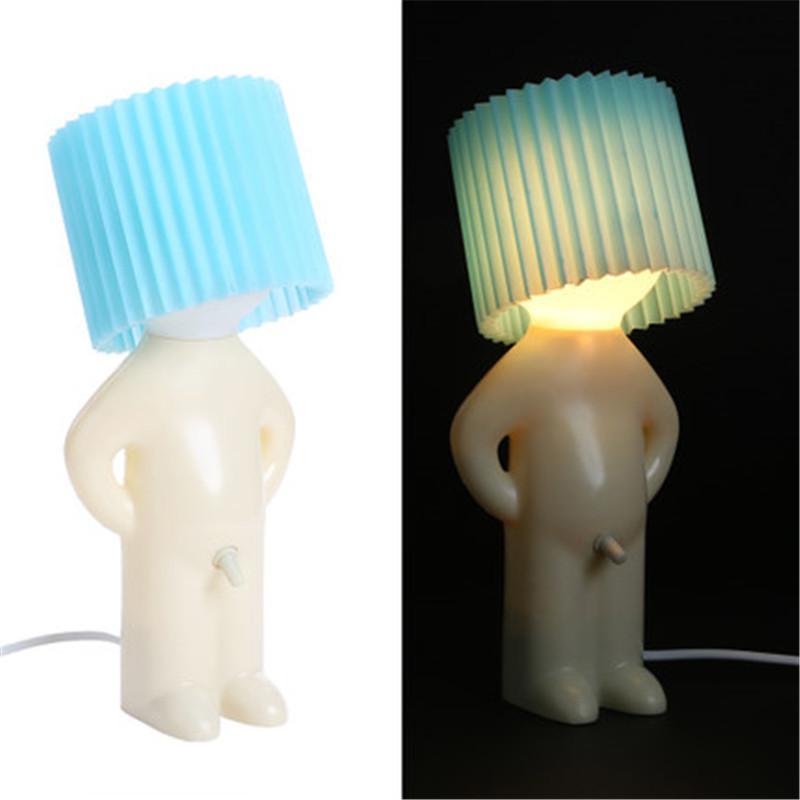 Two elephant-shaped lamps with pleated blue and green lampshades on a white background.