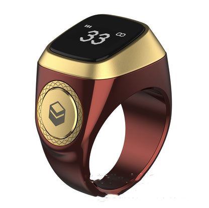Gold and red smart ring with digital display on a white background