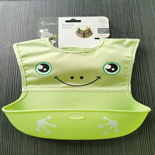 Green bib with smiley face design on a gray surface