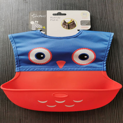 Blue and red bib with owl design on a gray surface