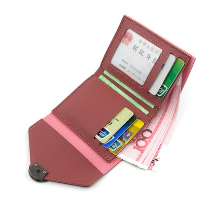 Pink wallet with various cards and a bill on a white background