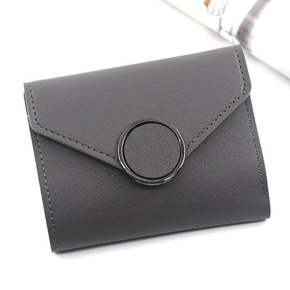 Gray wallet with a circular clasp on a white background