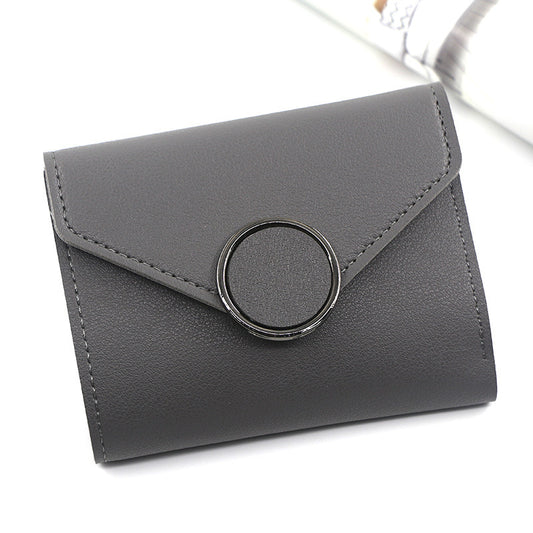 Gray wallet with a circular clasp on a white background