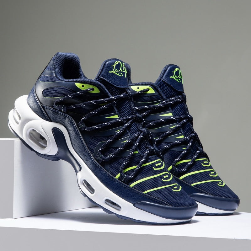 Navy and green sneakers with white sole on a gray background