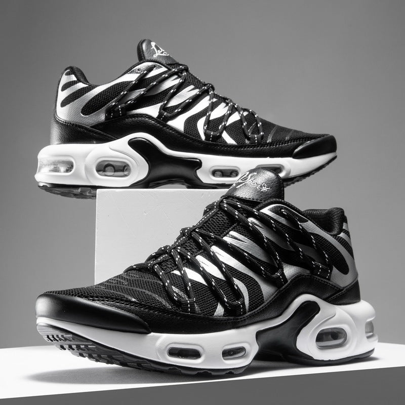 Black and white sneakers with zebra pattern on a gray background