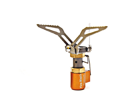 Portable camping stove with orange base and gold top on a white background