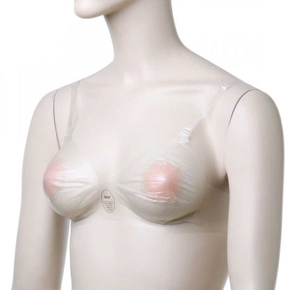 Mannequin with breast form on plain background