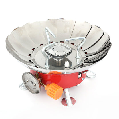 Portable gas stove with red base and silver top on a white background