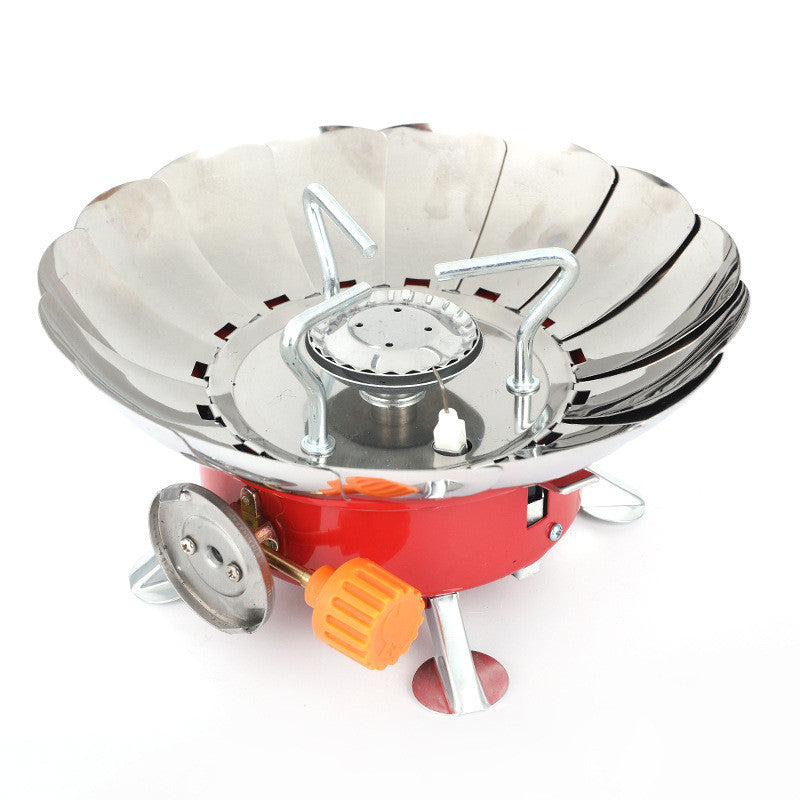 Portable gas stove with red base and silver top on a white background