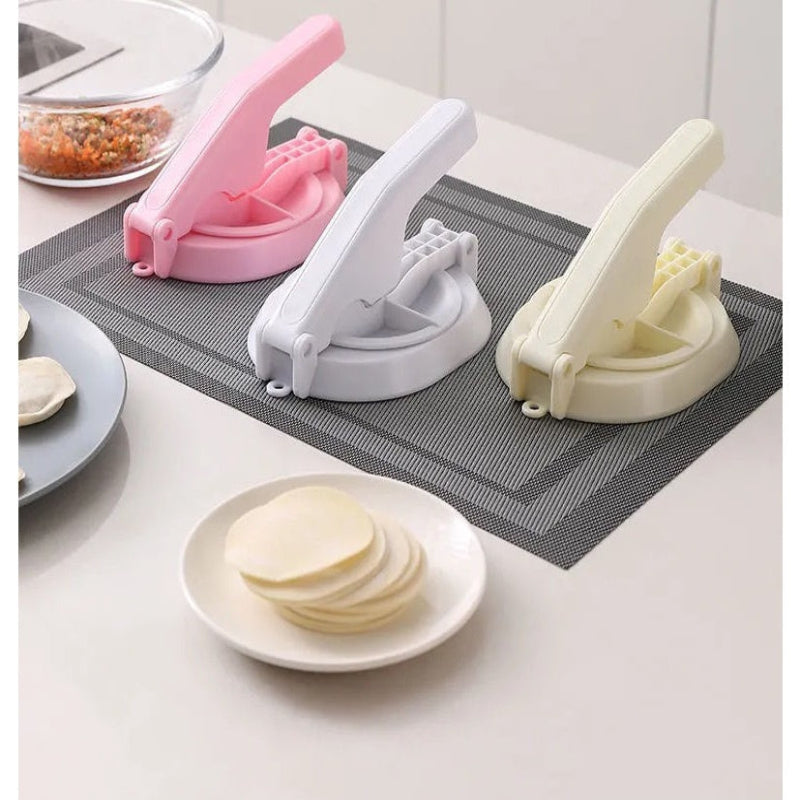Three dough cutters on a kitchen counter with a stack of pancakes.