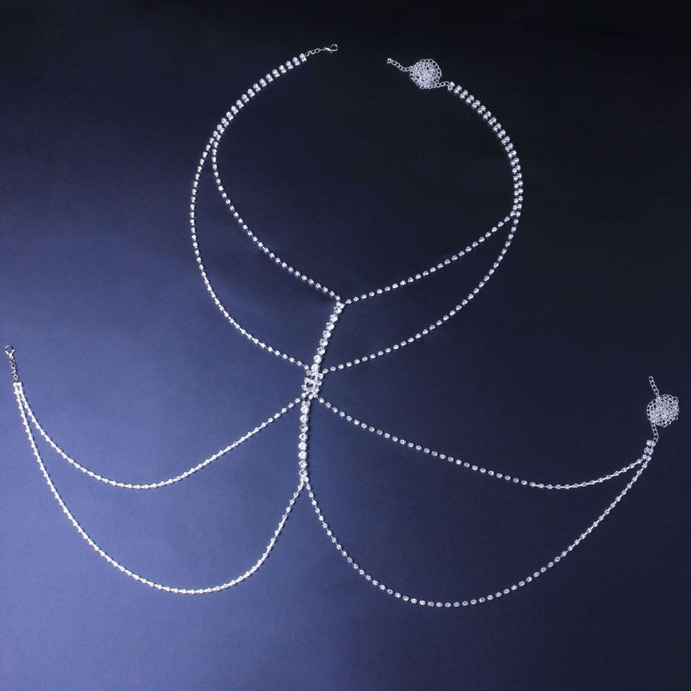 Silver necklace and earrings on a dark background
