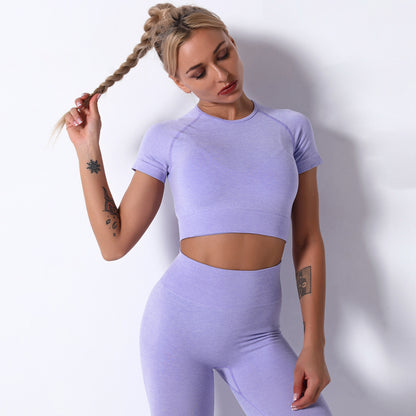 Woman wearing a light purple athletic outfit against a white background