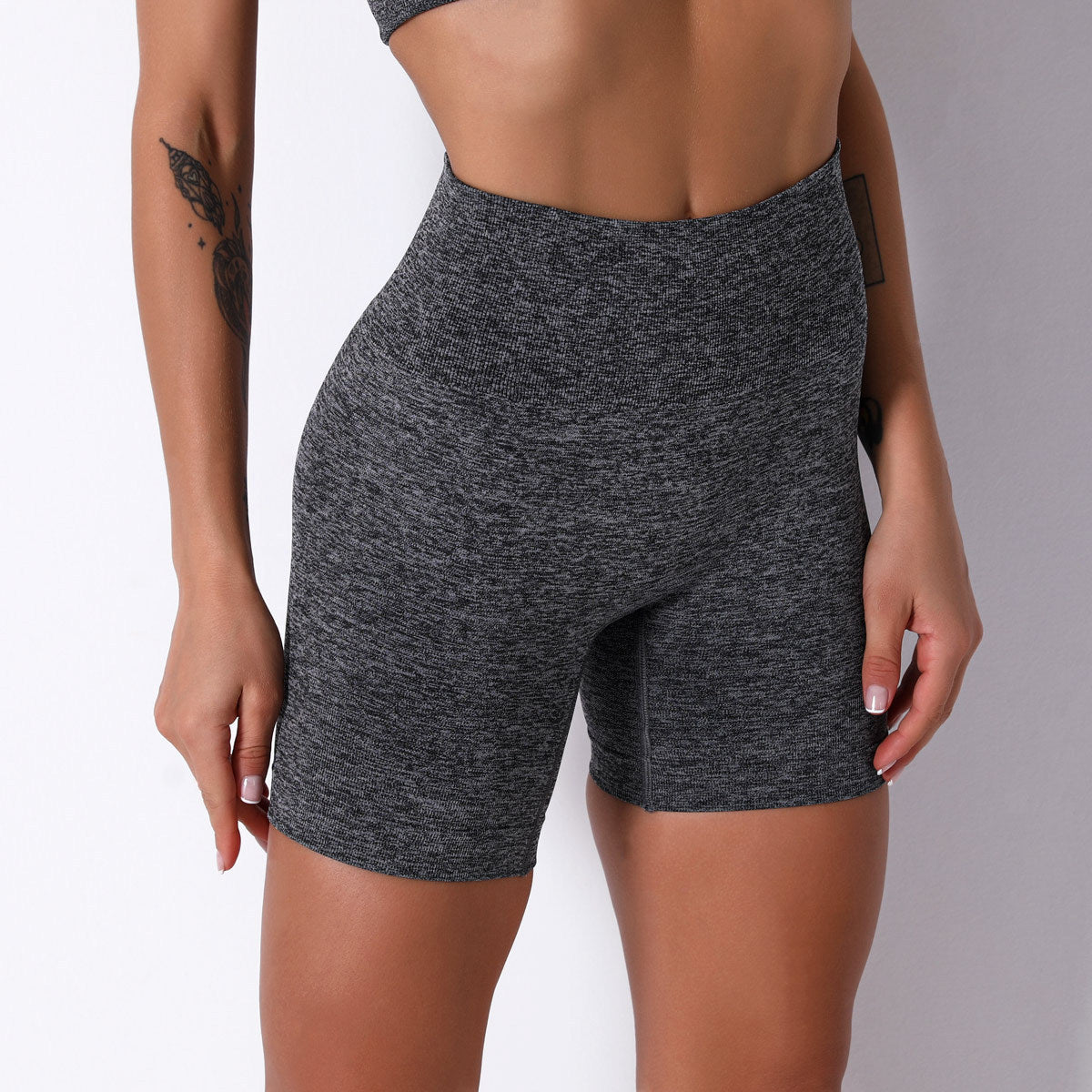 Person wearing gray athletic shorts on a white background