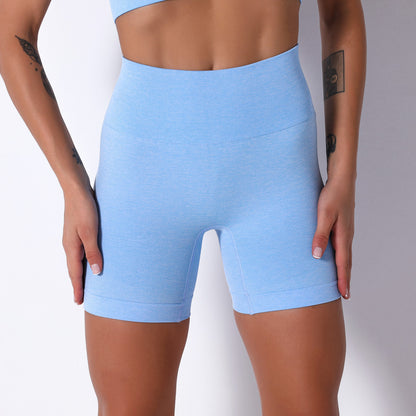 Light blue athletic shorts worn by a person on a white background
