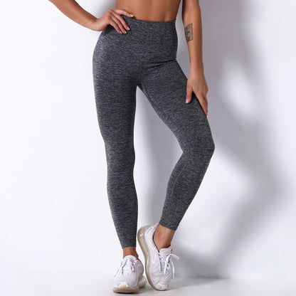 Person wearing gray leggings on a white background