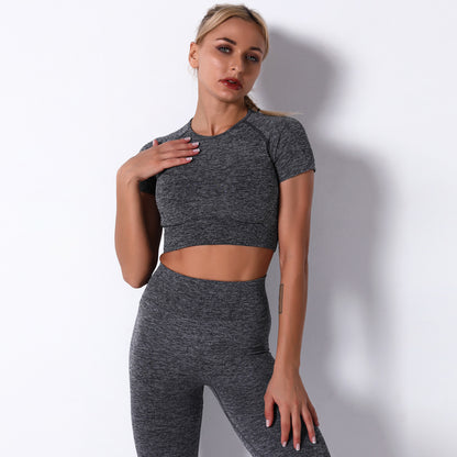 Woman wearing a gray athletic outfit on a white background