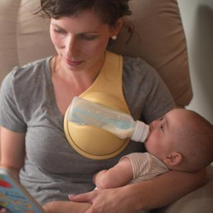 Woman breastfeeding a baby using a yellow哺乳枕 (breastfeeding pillow) while sitting on a couch.