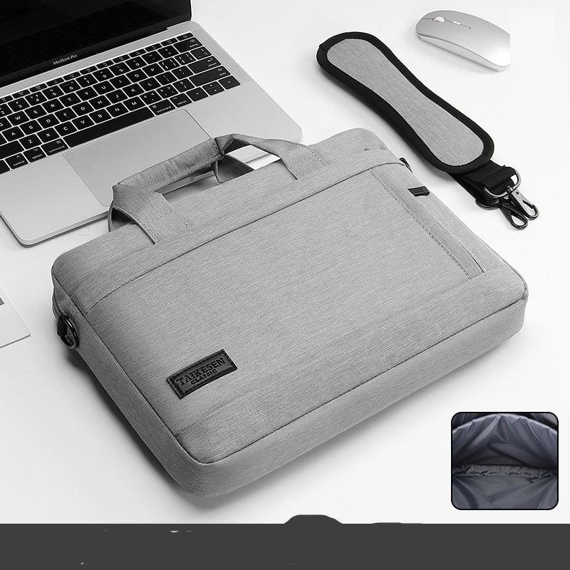 Black laptop bag with a handle and zipper closure, displayed next to a laptop and a mouse, with an inset showing the interior of the bag.