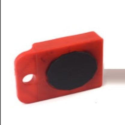Red rectangular object with a central black circle on a white background