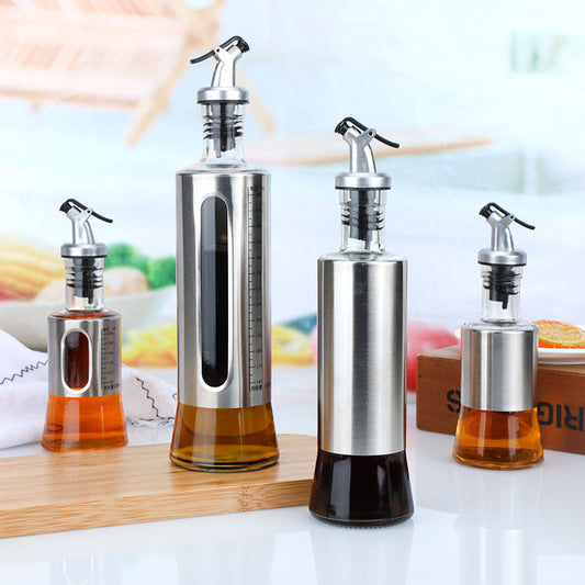 Set of four olive oil dispensers with different sizes on a table.