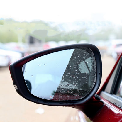 Car side mirror with raindrops on a blurred background