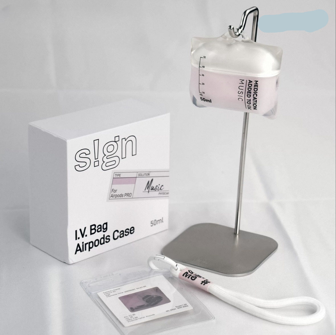 IV bag airpod case with packaging and accessories on a white background