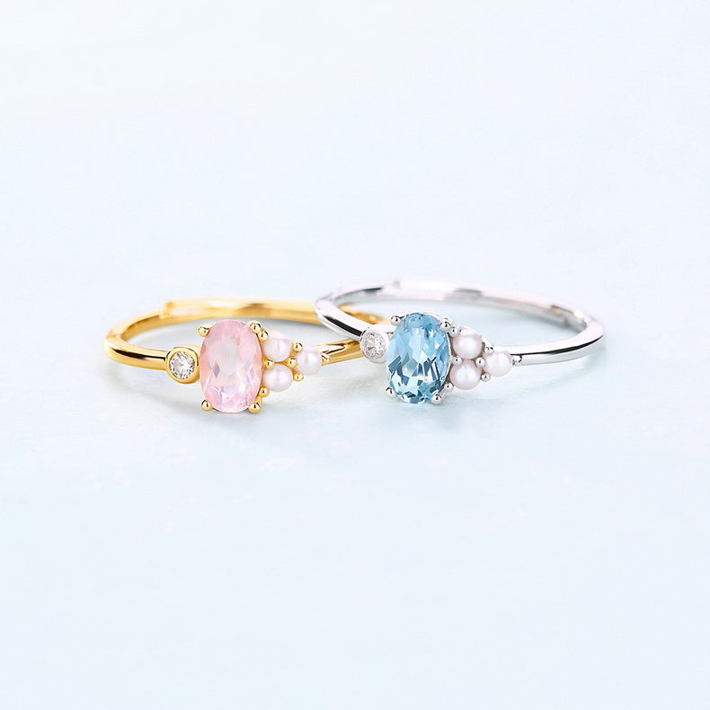 Two rings with gemstones on a light gray background