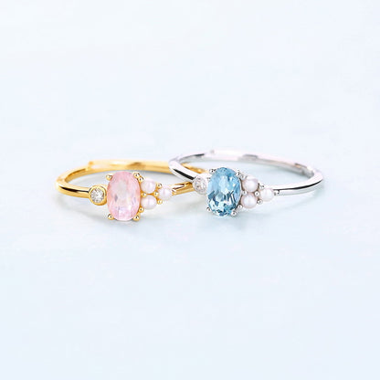 Two rings with gemstones on a light gray background
