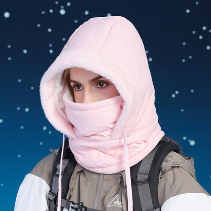 Person wearing a pink hood and scarf against a snowy background