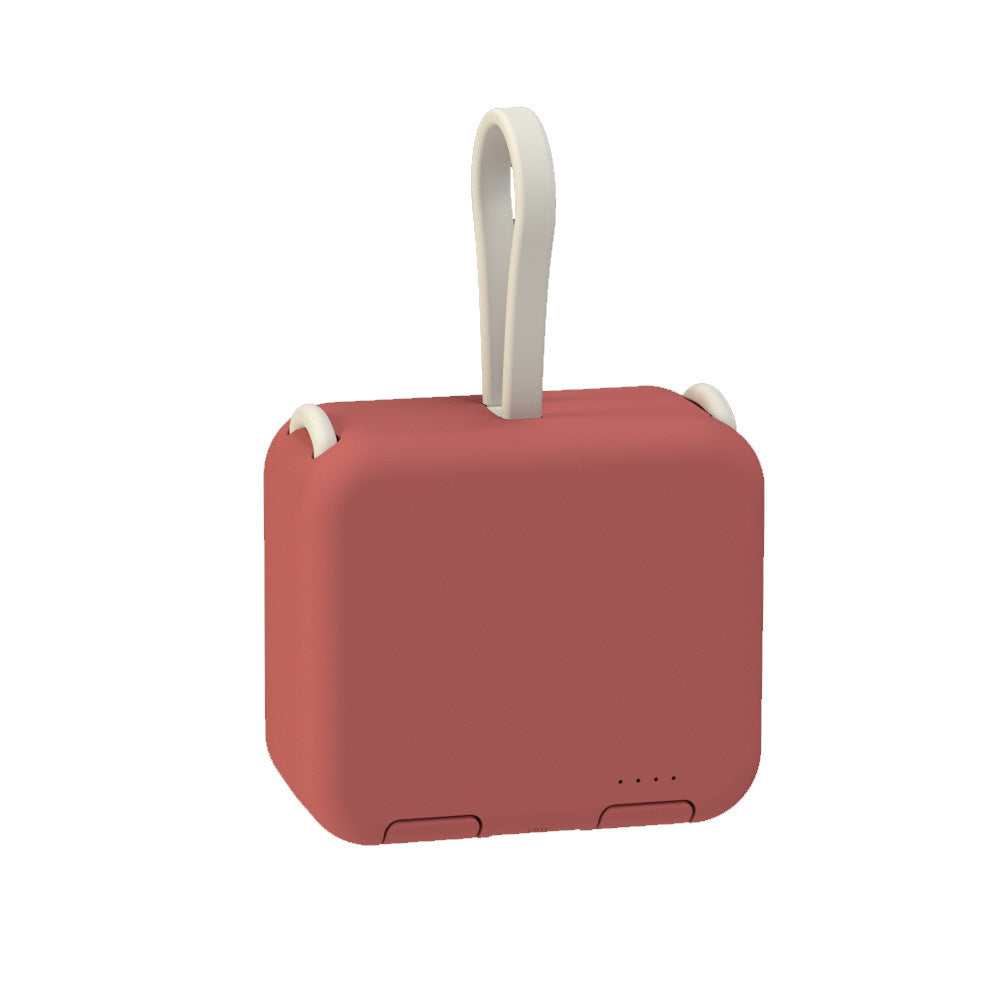 Red portable speaker with a white handle on a white background