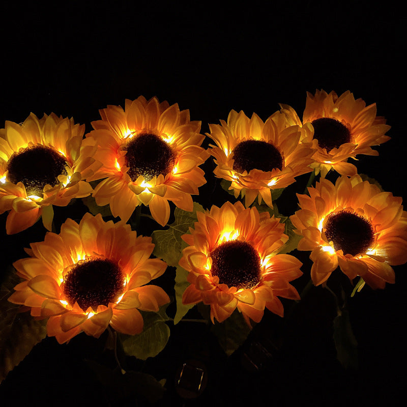 Group of illuminated sunflower lights against a dark background