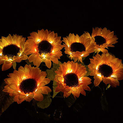 Group of illuminated sunflower lights against a dark background