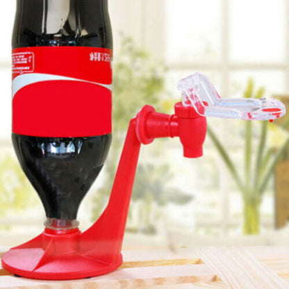 Red soda bottle cap removal tool attached to a Coca-Cola bottle.